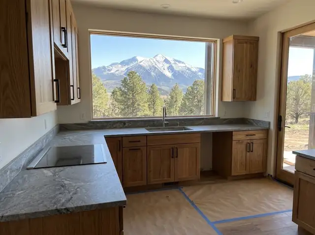 Just-finished kitchen with new oak cabinets and grey granite countertops